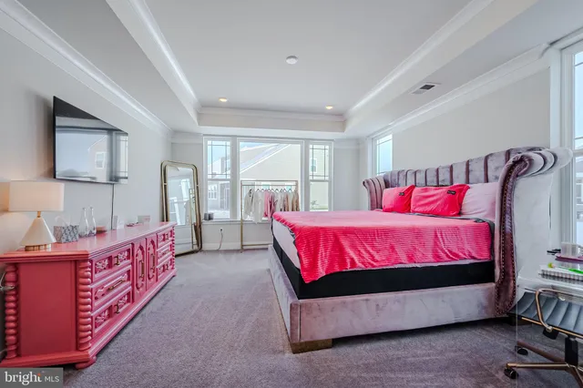 a spacious bedroom with a bed and window