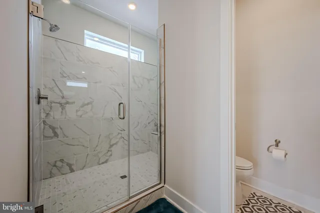 a bathroom with a shower and toilet
