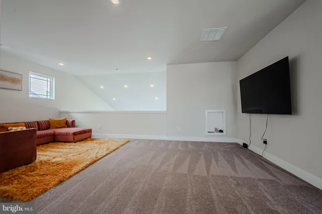 a living room with hard wood floor and a flat screen tv