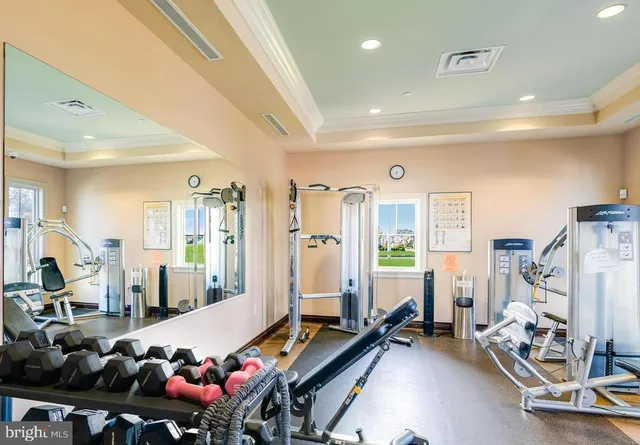 a room with gym equipment and a large window