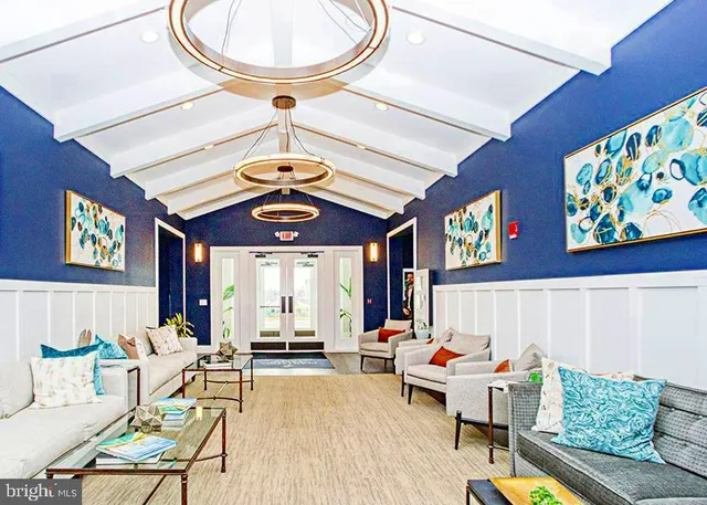 a living room with furniture a rug and a chandelier