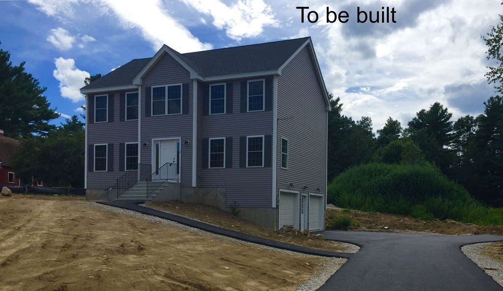 Lot 2-55-4 Old County Road Pelham, NH 03076 - Photo 1 of 16 a front view of a house with yard garden and trees