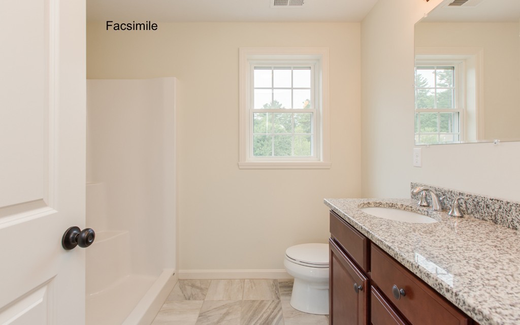 Lot 2-55-4 Old County Road Pelham, NH 03076 - Photo 12 of 16 a bathroom with a granite countertop sink a toilet and a window