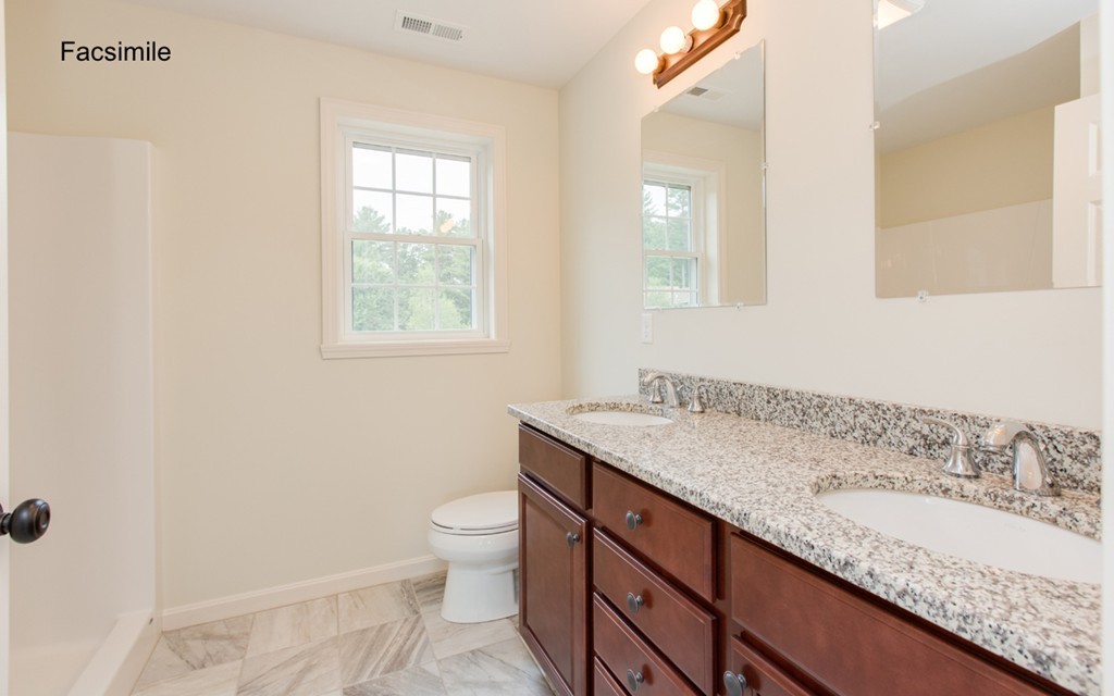 Lot 2-55-4 Old County Road Pelham, NH 03076 - Photo 14 of 16 a bathroom with a granite countertop sink a toilet and a window