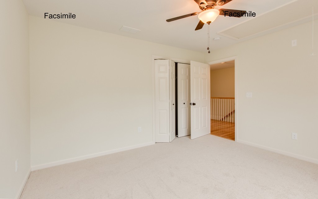 Lot 2-55-4 Old County Road Pelham, NH 03076 - Photo 16 of 16 an empty room with a chandelier fan and wooden floor