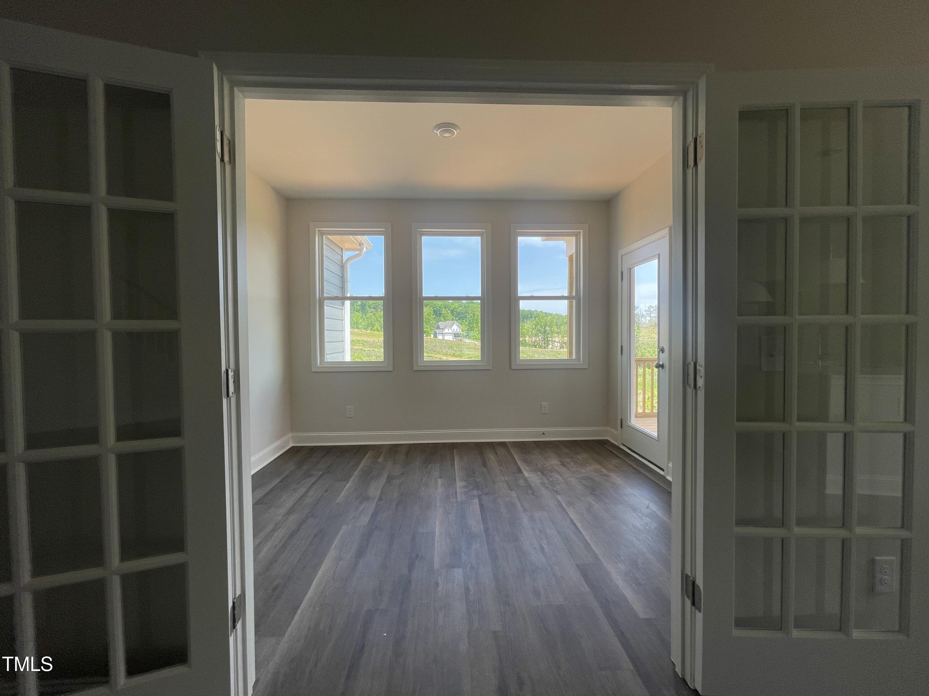 5848 Genesee Drive Durham, NC 27712 - Photo 7 of 14 a view of an empty room with wooden floor and a window