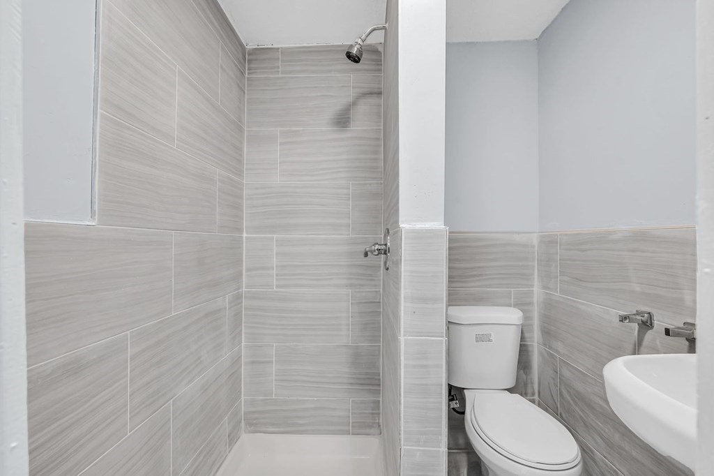 54 Littleton Street Springfield, MA 01104 - Photo 13 of 30 a white toilet sitting next to a bathroom sink
