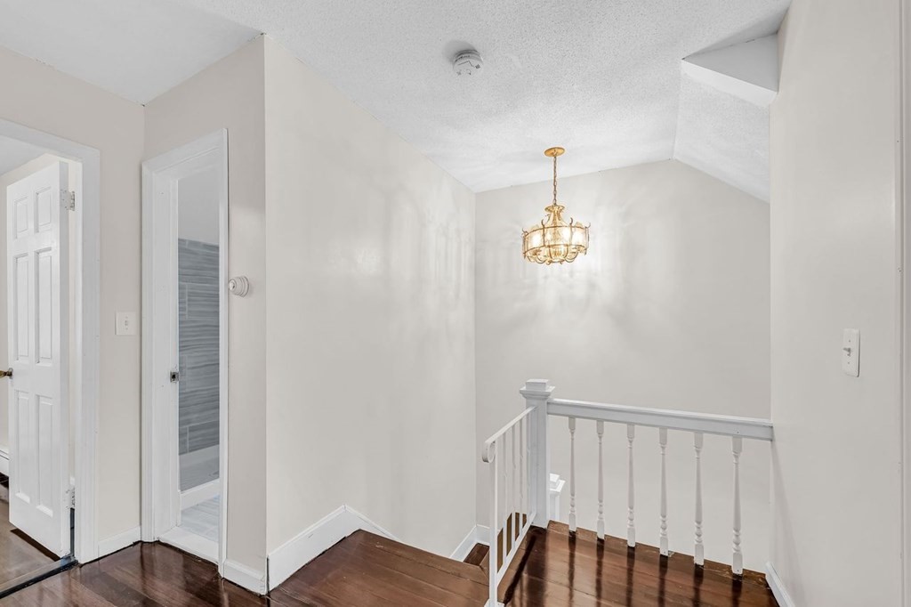 54 Littleton Street Springfield, MA 01104 - Photo 14 of 30 a view of a hallway with wooden floor