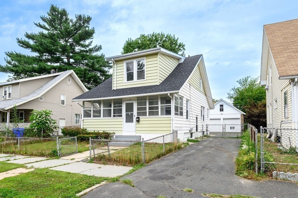 54 Littleton Street Springfield, MA 01104 - Photo 3 of 30 a view of a white house with a yard and plants