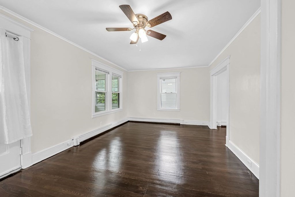 54 Littleton Street Springfield, MA 01104 - Photo 8 of 30 an empty room with wooden floor and windows