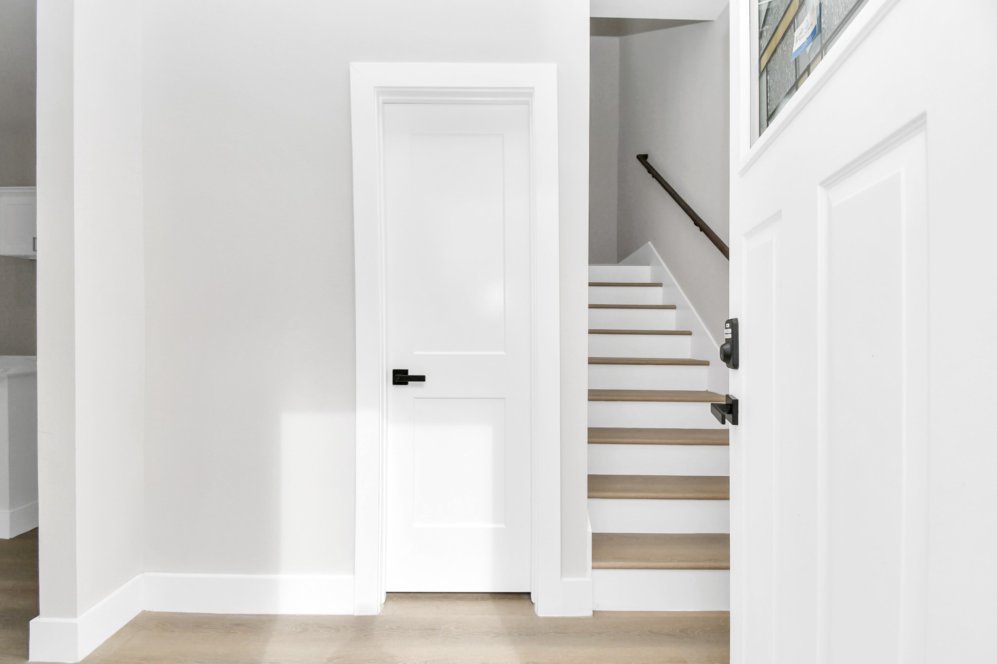 8409 Sunnyhill Street Houston, TX 77088 - Photo 8 of 13 a view of staircase with white walls and white door