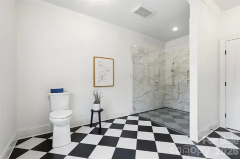 a bathroom with a black and white checkered floor