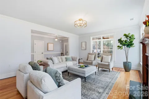 a living room with furniture a table and a potted plant