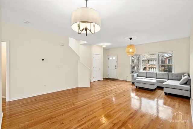 a view of livingroom with furniture wooden floor and chandelier