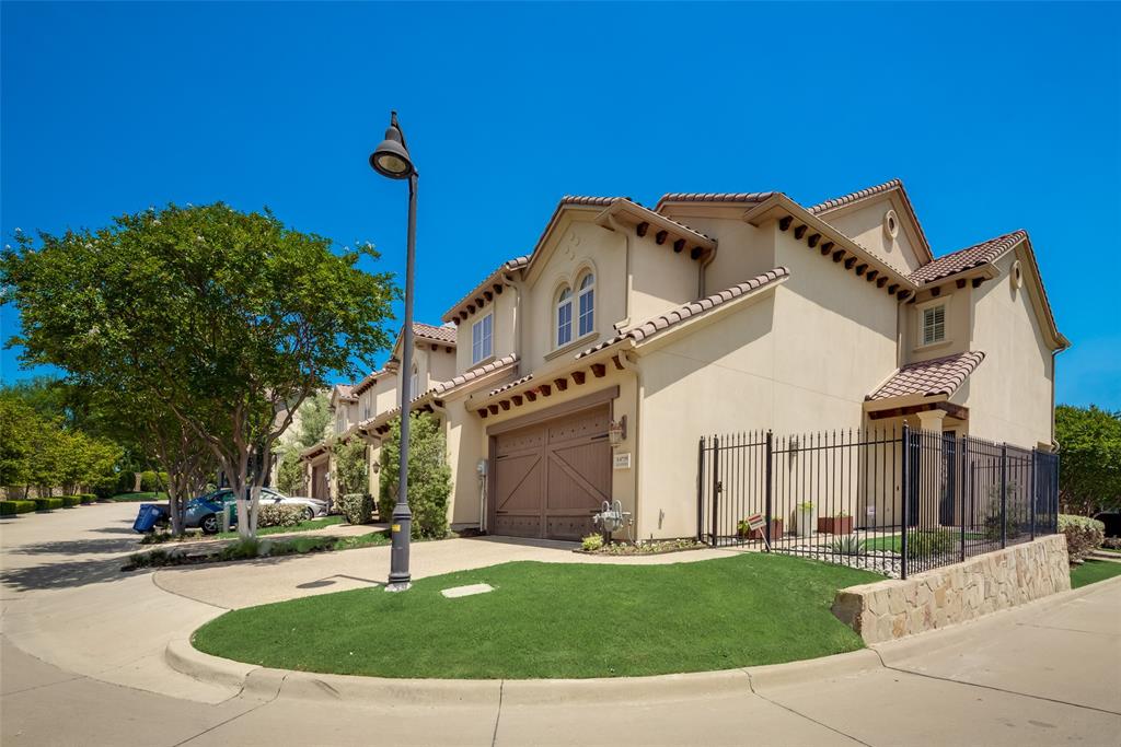 a view of a white house with a yard and plants