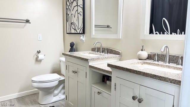 511 Nobottom Road Berea, OH 44017 - Photo 18 of 33 Bathroom featuring vanity, toilet, wood finished floors, and baseboards