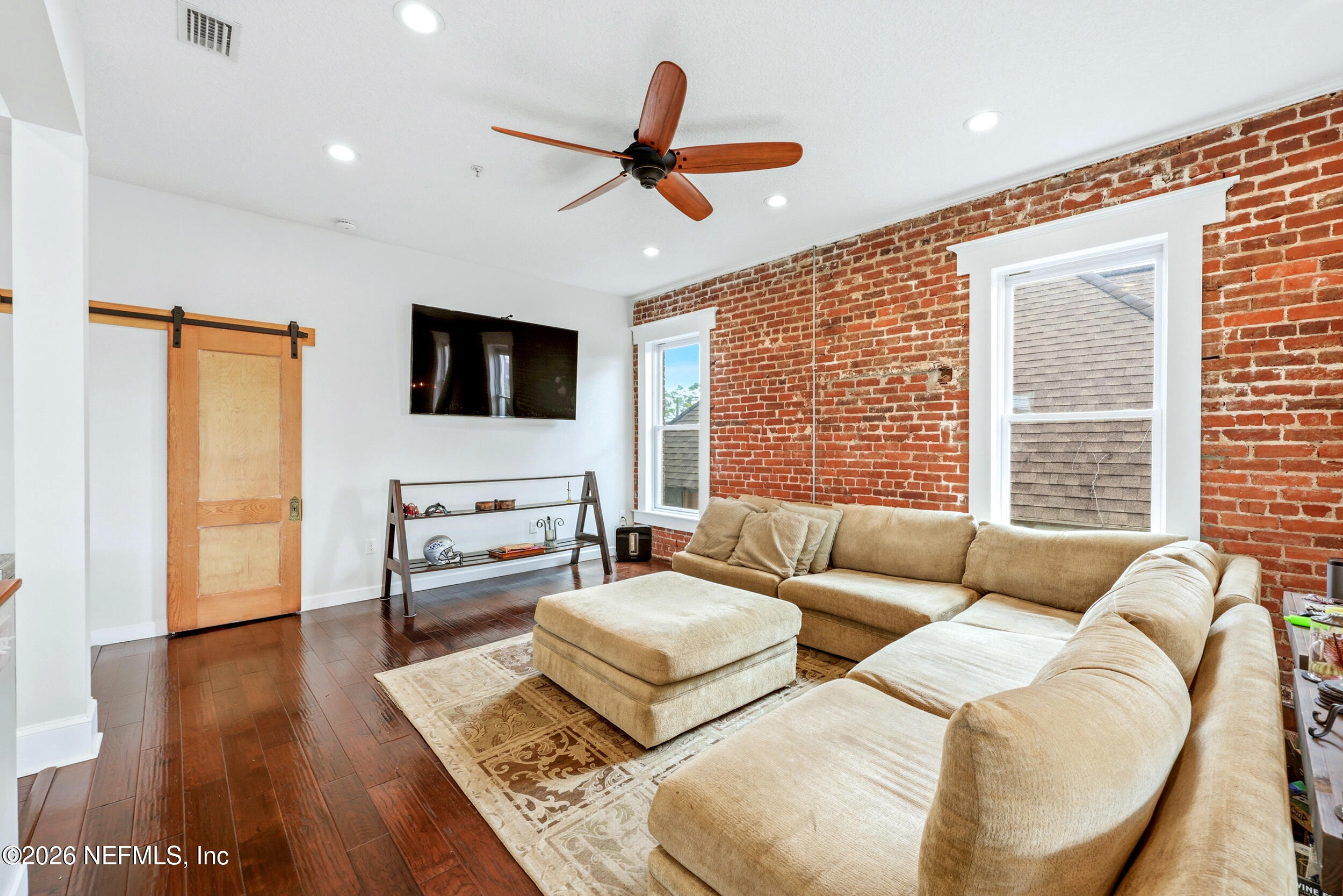 115 West 2nd Street Jacksonville, FL 32206 - Photo 43 of 96 a living room with furniture and a flat screen tv