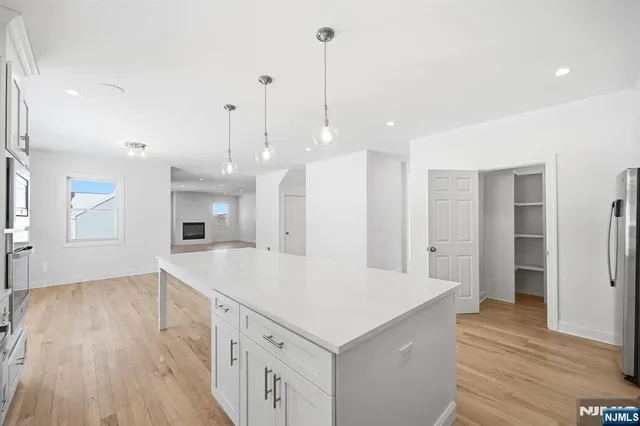 a view of a kitchen with wooden floor and a sink