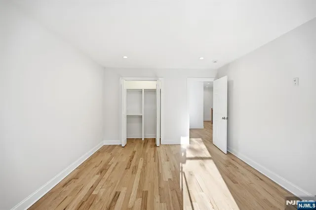 a view of a room with wooden floor and white walls