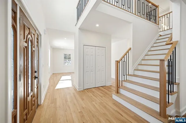 a view of a hallway with wooden floor and entryway