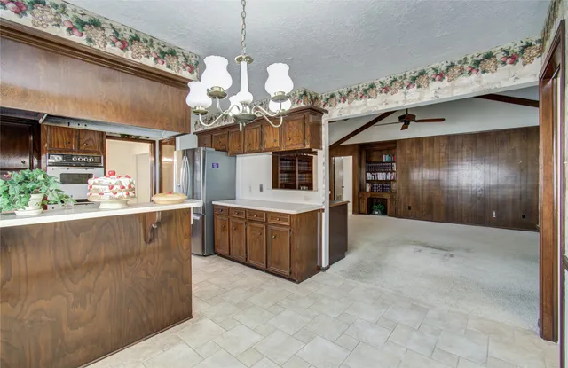 a kitchen with a sink appliances and cabinets