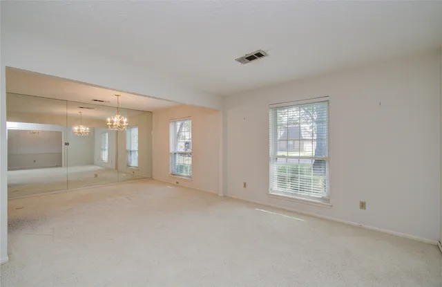 an empty room with windows and closet