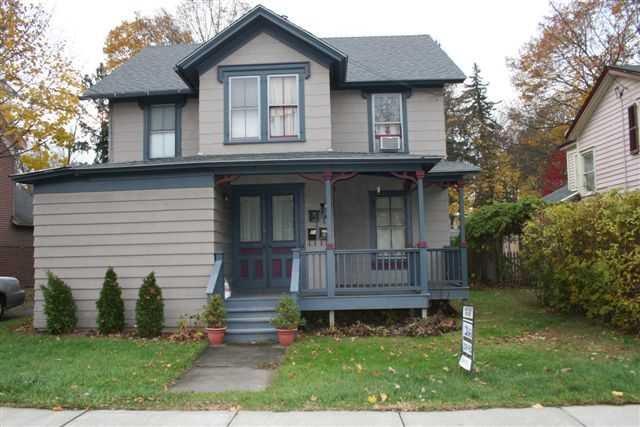 a front view of a house with a garden