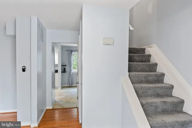 a view of a hallway with wooden floor and entryway