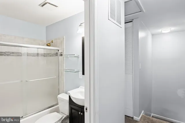 a bathroom with a shower and toilet