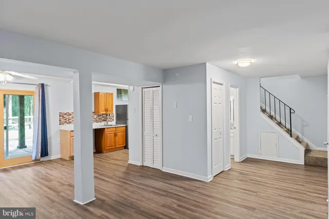 a view of entryway and hall with wooden floor