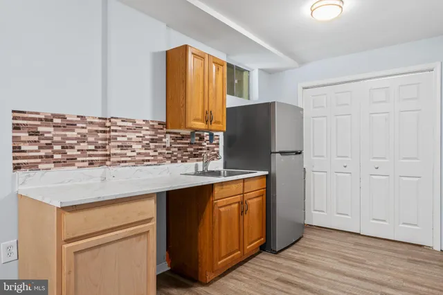 a kitchen with stainless steel appliances granite countertop a refrigerator and a stove