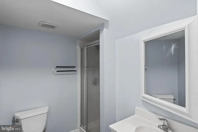 a white toilet sitting next to a bath tub