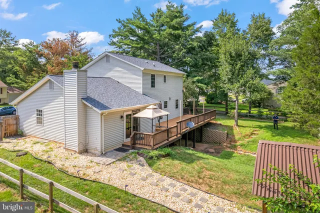 a view of a house with a yard and sitting area