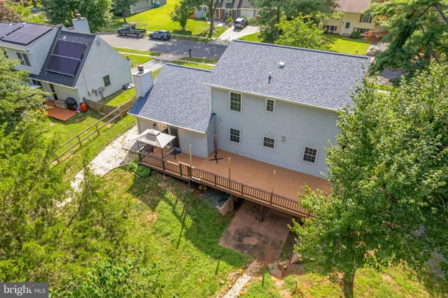 an aerial view of a house with a yard basket ball court and outdoor seating