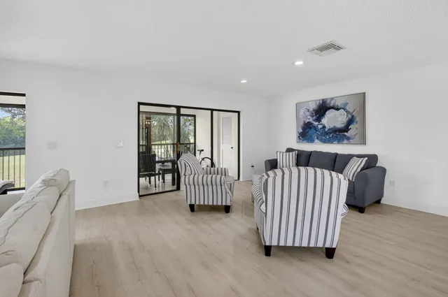 a bedroom with a bed and a flat tv screen on dresser