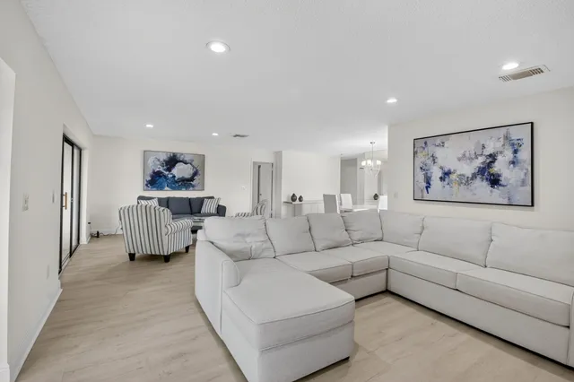 a bedroom with a bed and dresser with mirror