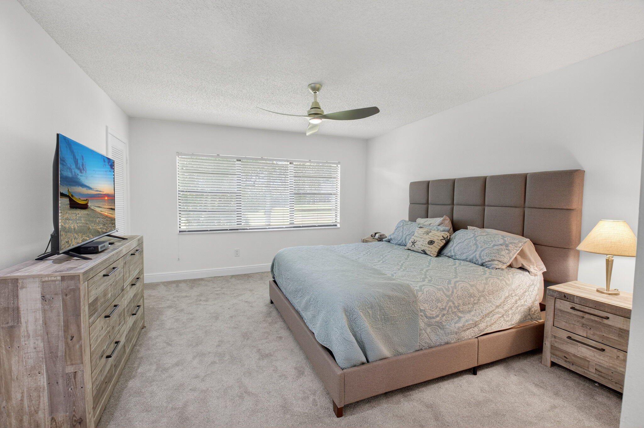 10 Southport Lane, Unit B Boynton Beach, FL 33436 - Photo 18 of 80 a bedroom with a bed and a flat screen tv