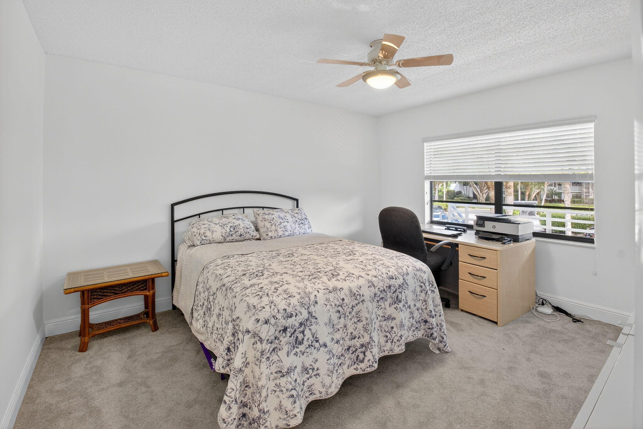 10 Southport Lane, Unit B Boynton Beach, FL 33436 - Photo 22 of 80 a bedroom with a white bed desk and chair with a bookshelf