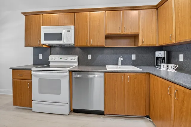 a view of a dining room with furniture large windows and wooden floor