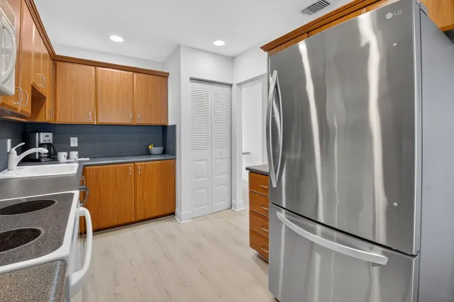 an aerial view of residential houses with outdoor space and street view