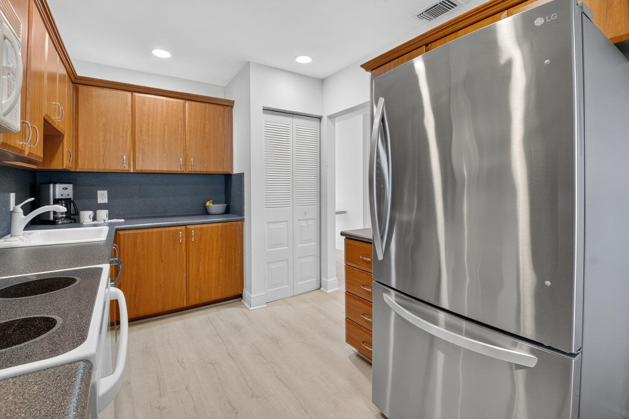 10 Southport Lane, Unit B Boynton Beach, FL 33436 - Photo 29 of 80 a kitchen with stainless steel appliances a refrigerator and a sink