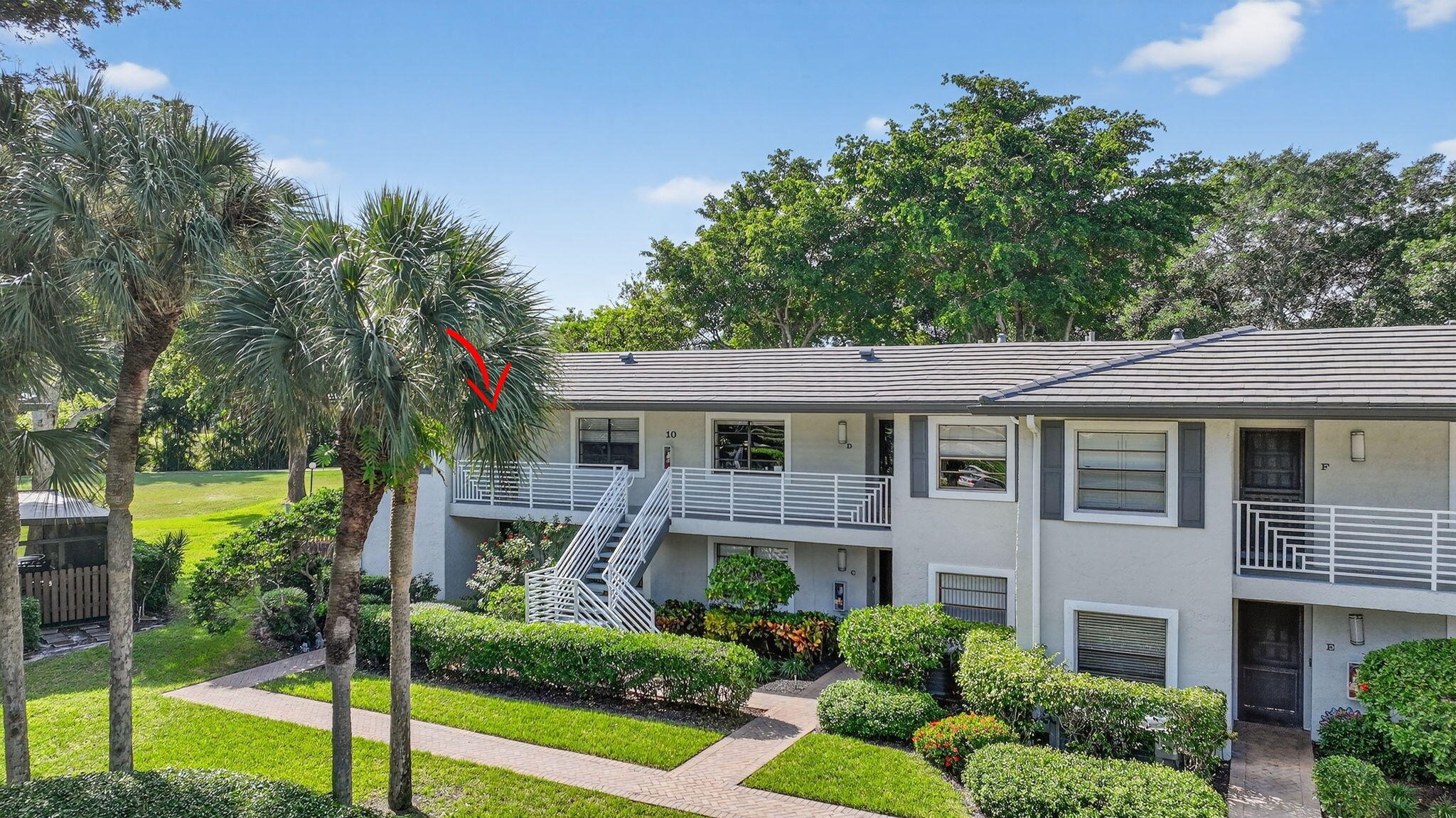 10 Southport Lane, Unit B Boynton Beach, FL 33436 - Photo 37 of 80 a front view of a house with garden