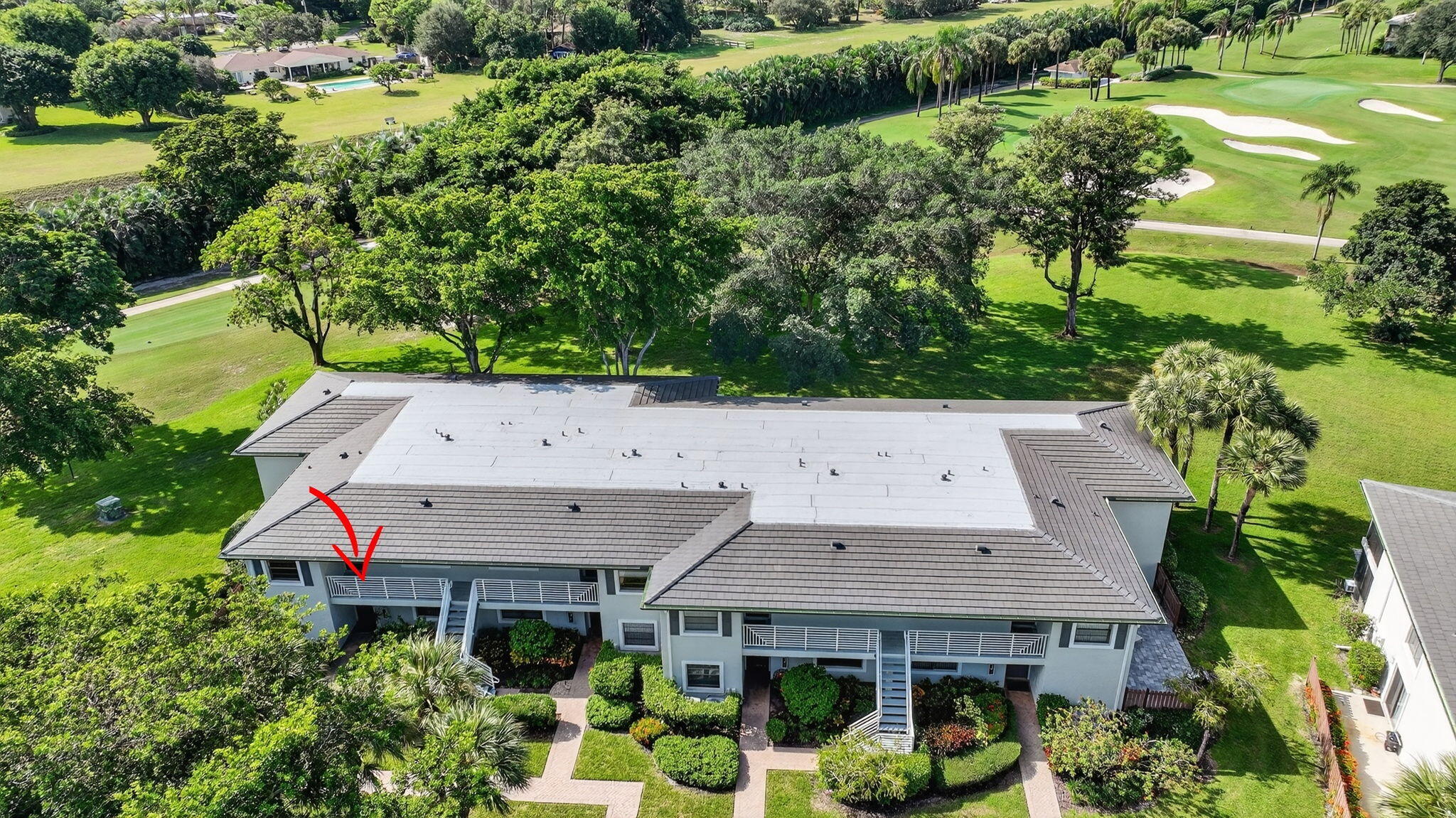 10 Southport Lane, Unit B Boynton Beach, FL 33436 - Photo 39 of 80 an aerial view of a house with swimming pool and large trees