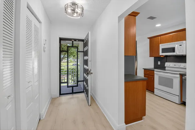 a view of a dining room with furniture and chandelier