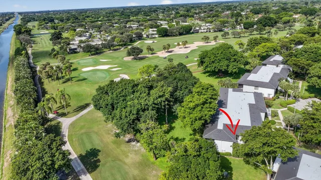 an aerial view of a house with a yard and lake view