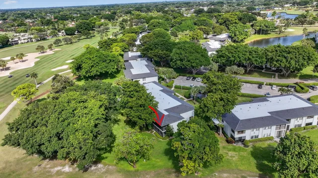 an aerial view of residential houses with outdoor space and trees