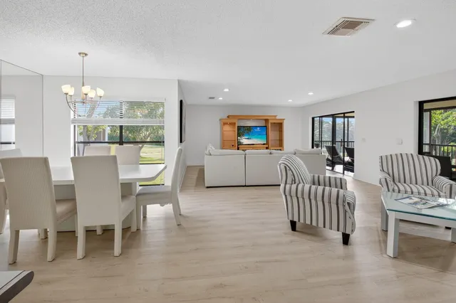a living room with furniture and large windows