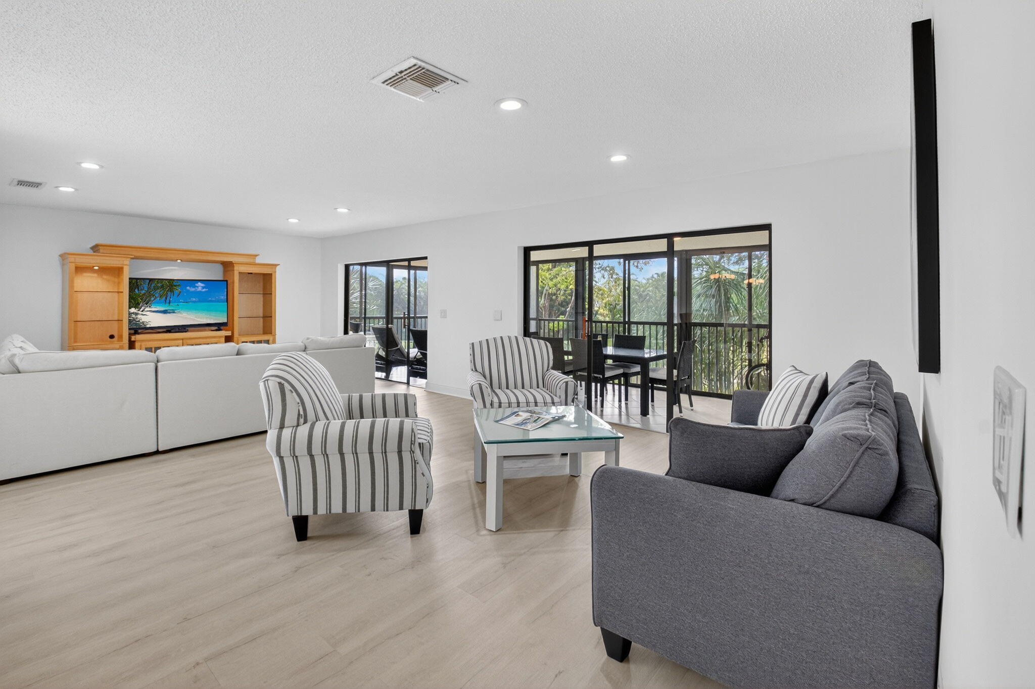 10 Southport Lane, Unit B Boynton Beach, FL 33436 - Photo 9 of 80 a living room with furniture and a flat screen tv