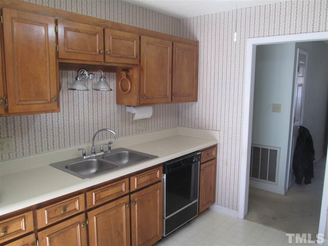 2600 Denbigh Court Raleigh, NC 27604 - Photo 7 of 13 a kitchen with stainless steel appliances granite countertop a sink and a refrigerator