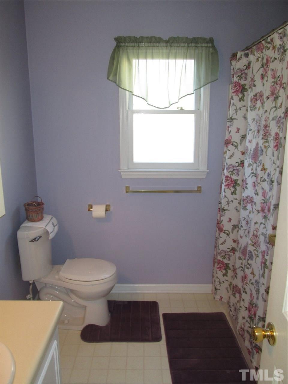 2600 Denbigh Court Raleigh, NC 27604 - Photo 9 of 13 a bathroom with a toilet and a shower